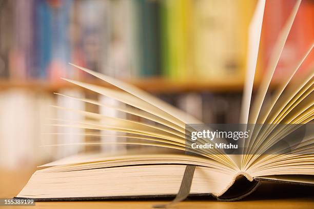 an open book with a leather bookmark - tale of tales uk premiere vip arrivals stockfoto's en -beelden