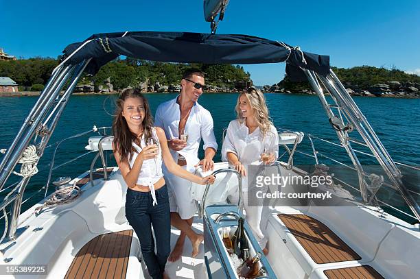 friends celebrating on boat with glass of champagne - sydney harbour boats stock pictures, royalty-free photos & images