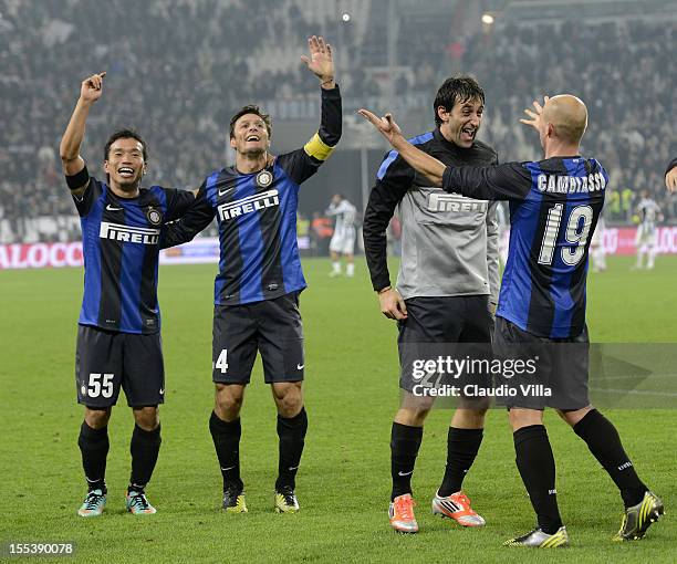 Yuto Nagatomo, Javier Zanetti, Diego Alberto Milito and Esteban Cambiasso of FC Inter Milan celebrate victory at the end of the Serie A match between...