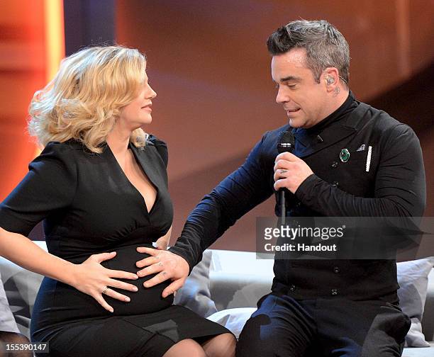 Barbara Schoeneberger and Robbie Williams meet during the 'Wetten dass..?' show on November 3, 2012 in Bremen, Germany.