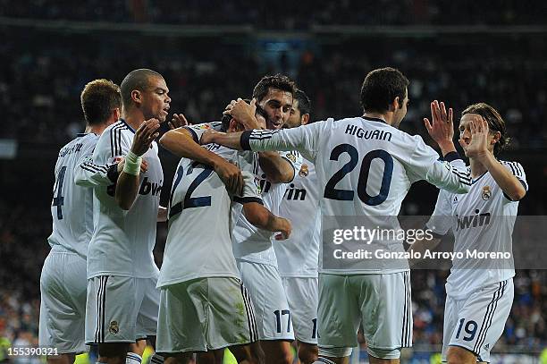 Angel Di Maria of Real Madrid CF celebrates scoring their second goal with teammates Sergio Ramos , Pepe , Alvaro Arbeloa , Gonzalo Higuain and Luka...