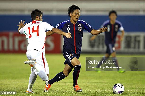 Yuya Kubo of Japan and M. Moradmand of Iran compete for the ball during the AFC U-19 Championship Group A match between Japan and Iran at Emirates...