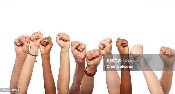 fists hands raised - raised fist stock pictures, royalty-free photos & images