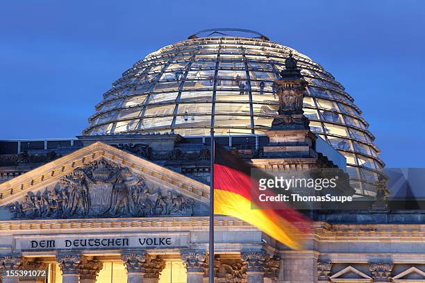 looking up at reichstag dome illuminated - german culture stock pictures, royalty-free photos & images