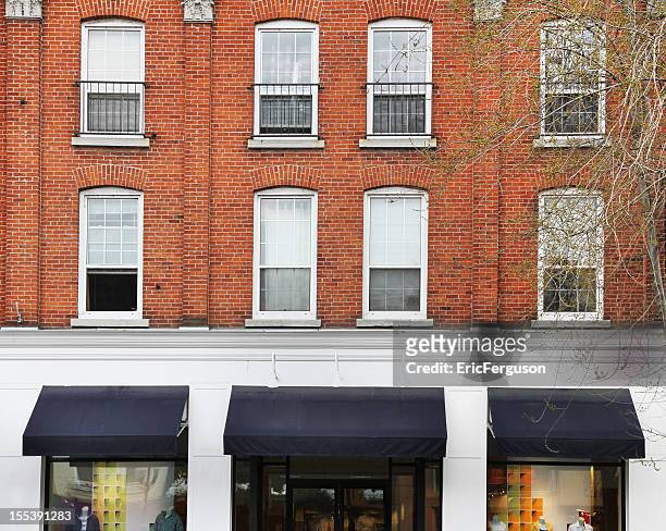 downtown store with brick and awnings - small apartment building exterior stock pictures, royalty-free photos & images