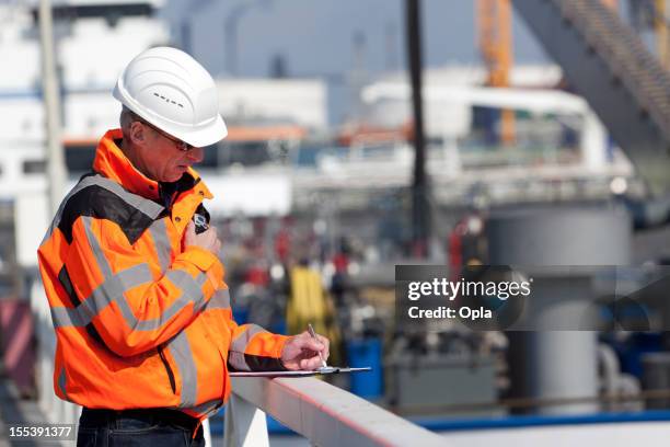 dockworker giving instructions - rotterdam netherlands stock pictures, royalty-free photos & images