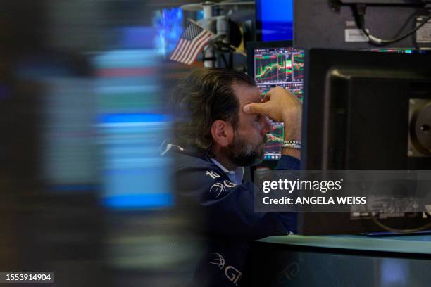 Traders work the floor of the New York Stock Exchange on July 25 in New York City. Wall Street stocks were mixed early July 25 following a round of...