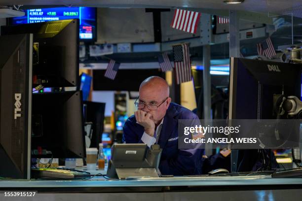 Traders work the floor of the New York Stock Exchange on July 25 in New York City. Wall Street stocks were mixed early July 25 following a round of...