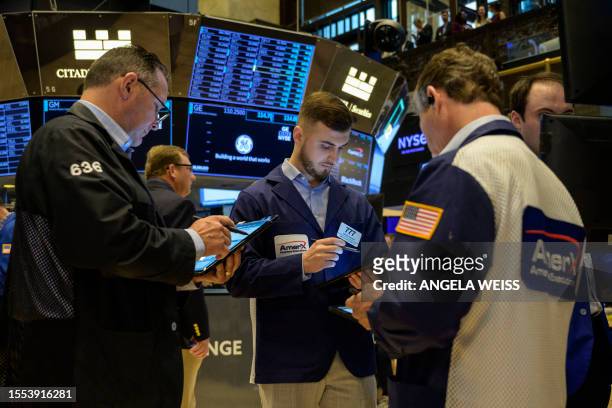 Traders work the floor of the New York Stock Exchange on July 25 in New York City. Wall Street stocks were mixed early July 25 following a round of...
