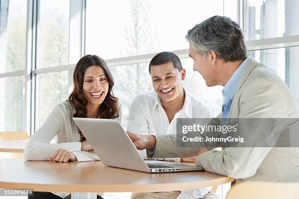financial consultant advising couple - insurance agent stock pictures, royalty-free photos & images