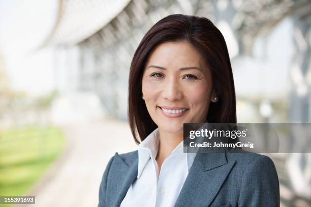 asian businesswoman smiling - corporate portraits depth of field stock pictures, royalty-free photos & images