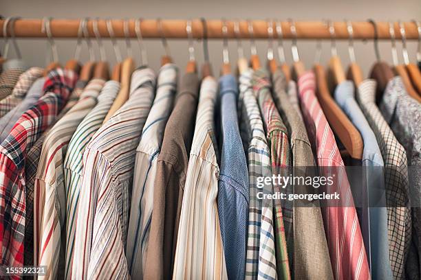 shirts on hangers - clothes wardrobe stockfoto's en -beelden