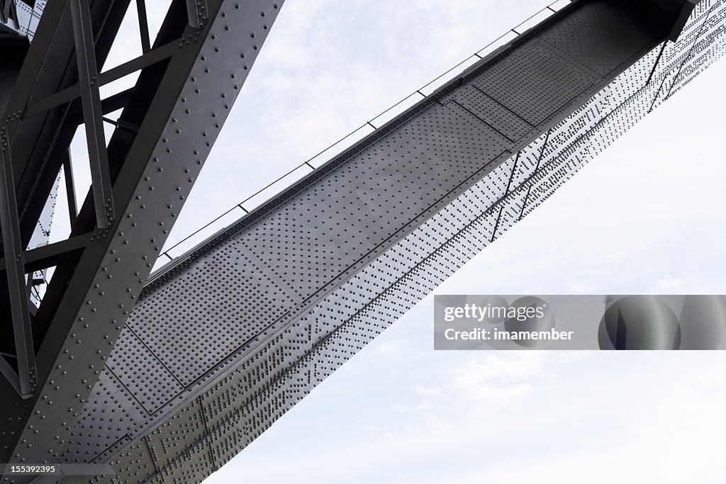 Low angle view large iron beam under bridge, copy space