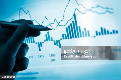 Hand pointing with pen on a computer chart / document Hand pointing with pen on a computer chart / document