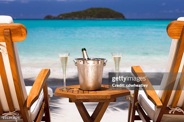 champagne and recliners on a tropical beach in the caribbean - honeymoon stock pictures, royalty-free photos & images