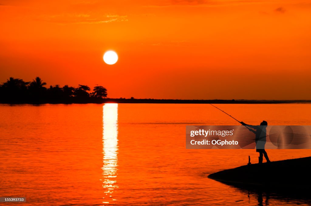 Man fishing during sunset