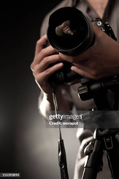 camera with professional lens being held - photographer stockfoto's en -beelden