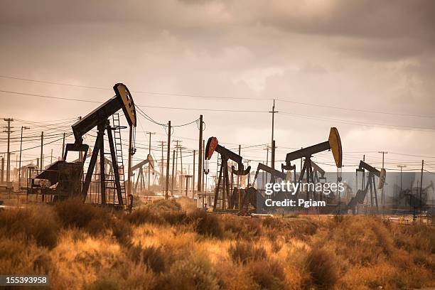 oil industry well pumps - oil field stockfoto's en -beelden