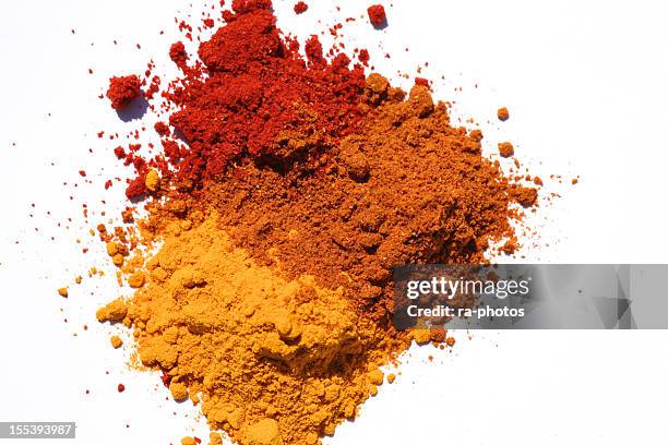 three different powdered spices in a white background - indian spices stockfoto's en -beelden