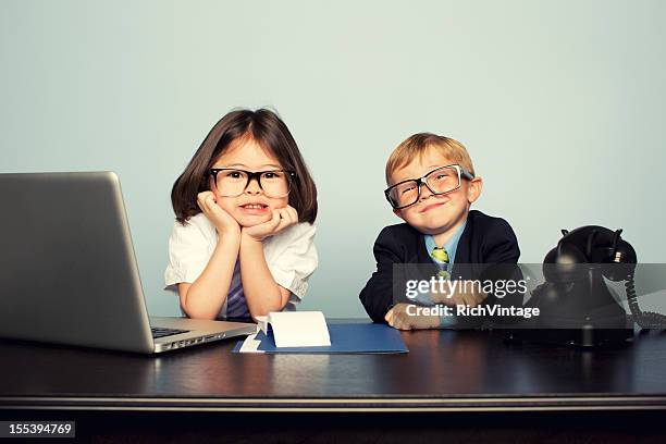 young business children sitting at desk with laptop - girl in office stock pictures, royalty-free photos & images