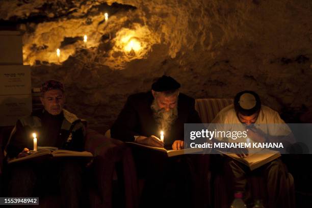 Kabbalist Rabi Uri Revach and his students read religious texts on candle light during overnight Kabbalah studies inside a Jerusalem mountain cave...