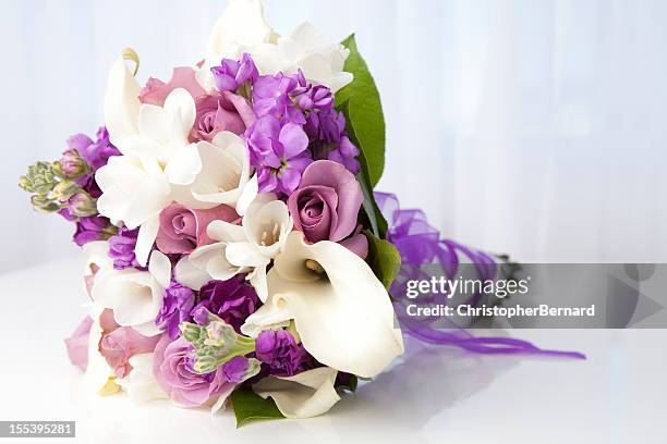 purple and white bridal bouquet - bouquet of flowers stock pictures, royalty-free photos & images