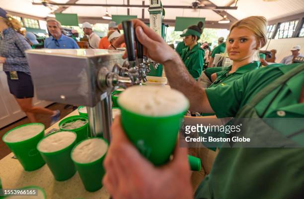 Augusta, GA An Augusta National Golf Club employee pours beers into souvenir cups at the 2023 Masters Tournament.