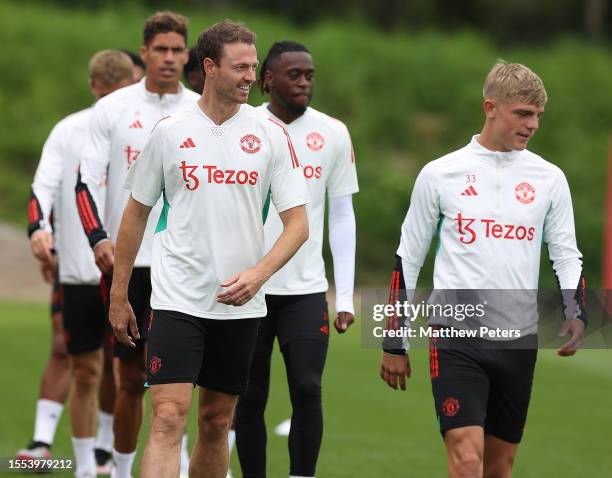 Jonny Evans, Brandon Williams of Manchester United in action during a first team training session at Carrington Training Ground on July 18, 2023 in...