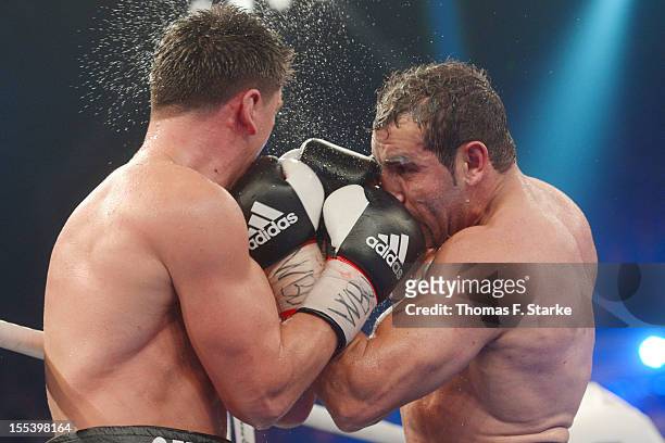 Marco Huck of Germany and Firat Arslan of Germany exchange punches during their WBO World Championship Cruiserweight title fight at Gerry Weber...