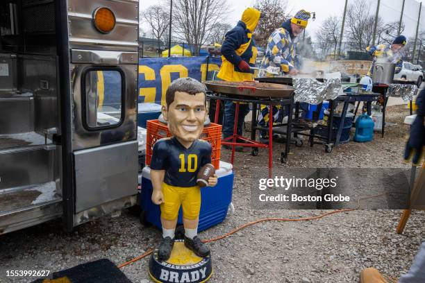 Ann Arbor, MI Tailgating outside Michigan Stadium, the biggest college football stadium in the USA as a statue of Michigan alum Tom Brady guards the...