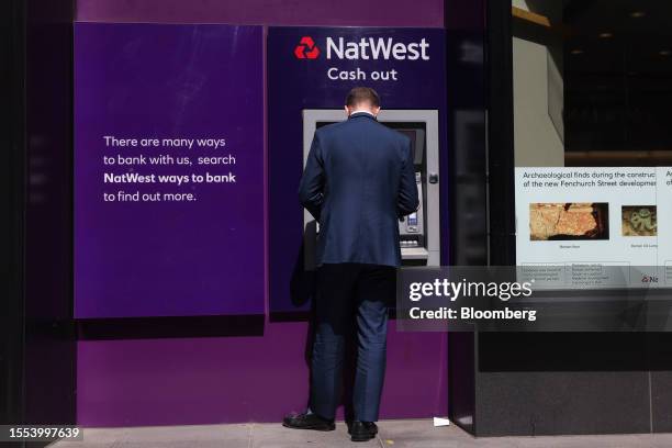 Customer uses an automated teller machine outside a NatWest Group Plc bank branch in London, UK, on Tuesday, July 25, 2023. Natwest is due to report...