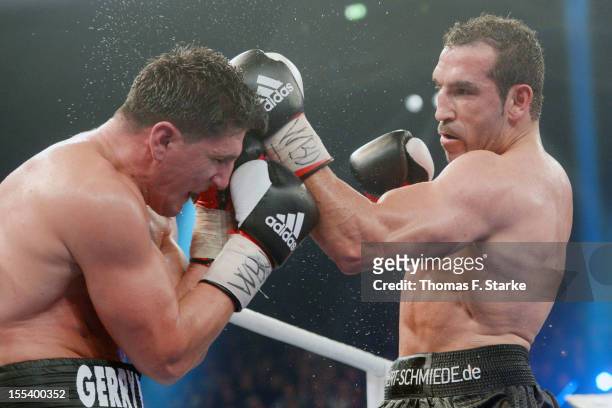 Marco Huck of Germany and Firat Arslan of Germany exchange punches during their WBO World Championship Cruiserweight title fight at Gerry Weber...