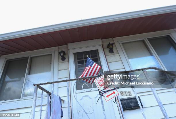 Sandy's Parking Only" sign hangs on the railing of a house devastated by Superstorm Sandy on November 2, 2012 in Union Beach, New Jersey. Over 200...