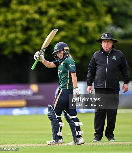 Dublin , Ireland - 25 July 2023; Amy Hunter of Ireland holds her bat aloft and acknowledges the crowd after bringing up her half century during match...