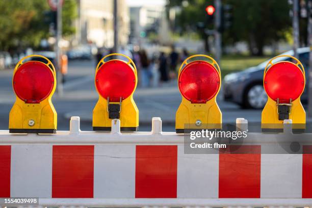 four red warning lights at a construction site on the street - stop sign stock pictures, royalty-free photos & images