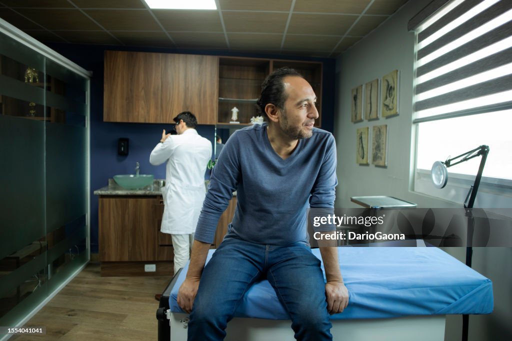 Neurologist consulting with male patient