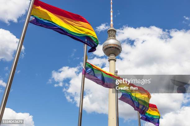 rainbow flags with berlin television tower (fernsehturm, germany) - berlin gay pride stock pictures, royalty-free photos & images