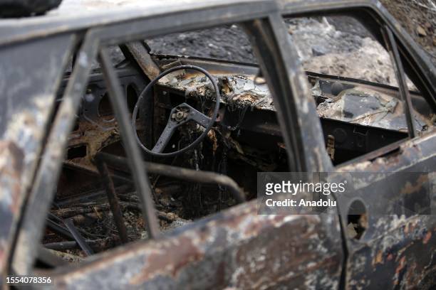 Heavily damaged vehicle is seen as deadly wildfires ravage settlements along the country's Mediterranean coast and firefighters continue their...