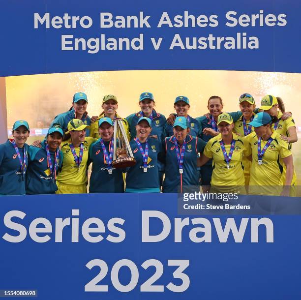 The Australia players celebrate with the trophy after retaining the Ashes after the Women's Ashes 3rd We Got Game ODI match between England and...