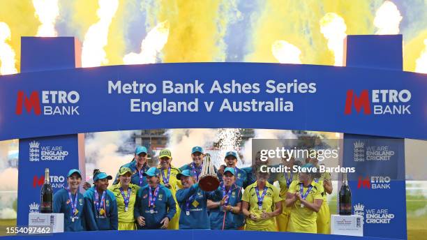 The Australia players celebrate with the trophy after retaining the Ashes after the Women's Ashes 3rd We Got Game ODI match between England and...