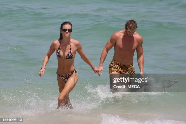 Nina Agdal and Logan Paul are seen taking a dip in the ocean while on vacation on July 22, 2023 in Miami Beach, Florida.