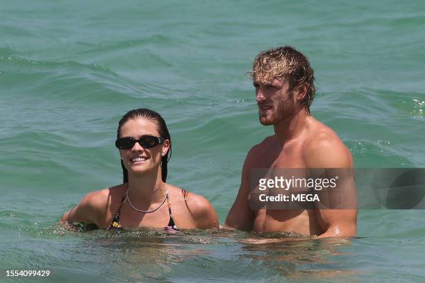 Nina Agdal and Logan Paul are seen taking a dip in the ocean while on vacation on July 22, 2023 in Miami Beach, Florida.