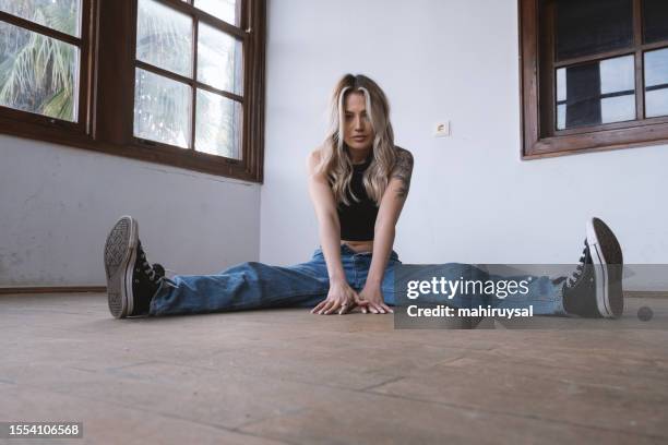 jeune femme blonde en jeans - jambes écartées photos et images de collection