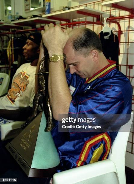 Phil Smith the Adelaide 36''ers coach clutches the Mitsubishi Challenge Trophy, after his teams victory over the Victoria Titans, in Game 3 of the...