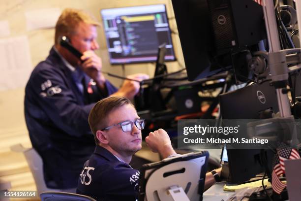 Traders work on the floor of the New York Stock Exchange during afternoon trading on July 18, 2023 in New York City. Stocks closed slightly high...