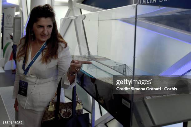 People look at the model of del The Strait of Messina Bridge , a planned suspension bridge across the Strait of Messina aimed to connect Sicily with...