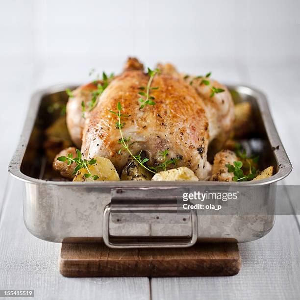 roasted chicken with potatoes - roasted chicken stock pictures, royalty-free photos & images