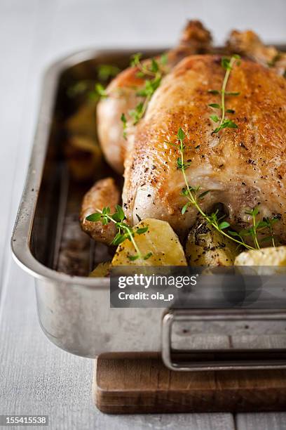 roasted chicken with potatoes - roasted chicken stock pictures, royalty-free photos & images