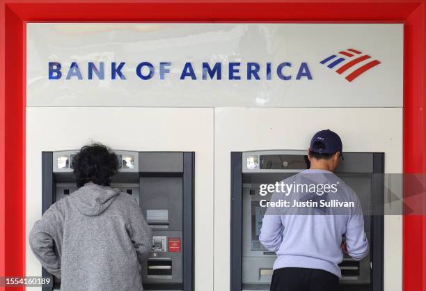Customers use an ATM at a Bank of America office on July 18, 2023 in Daly City, California. Bank of America reported second quarter earnings that...
