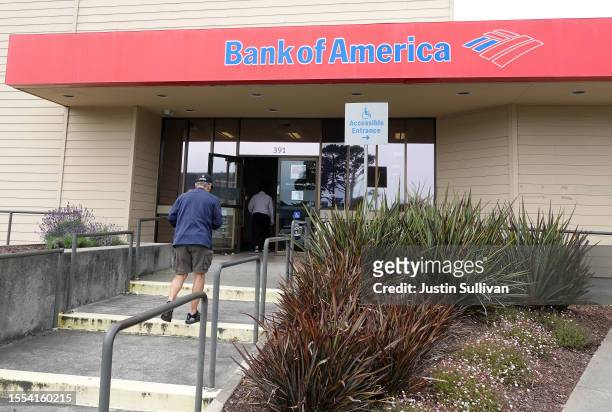 Customers enter a Bank of America office on July 18, 2023 in Daly City, California. Bank of America reported second quarter earnings that beat...